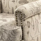 Wooden Upholstered Floral Pattern Armchair with Panel Arms and Camelback